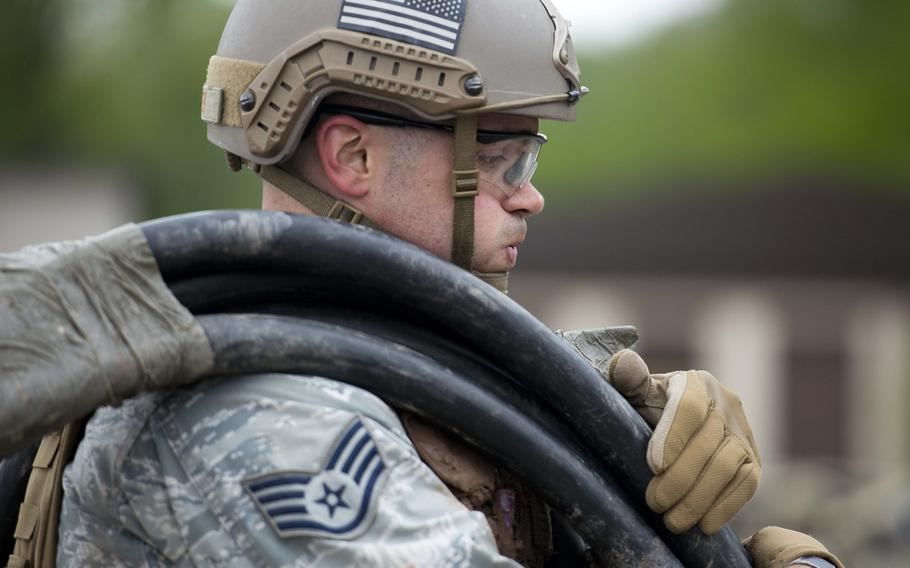 Staff Sgt. Jordan Lucey, from the 435th Security Forces Squadron, carries a roll of cable during the 435th Contingency Response Group Olympics at Ramstein Air Base, Germany, on Friday, May 5, 2017.