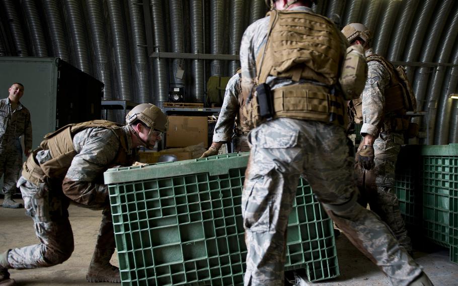 1st Lt. Jeffery Davis, left, from the 435th Security Forces Squadron, loads a container onto a pallet during the 435th Contingency Response Group Olympics at Ramstein Air Base, Germany, on Friday, May 5, 2017.
