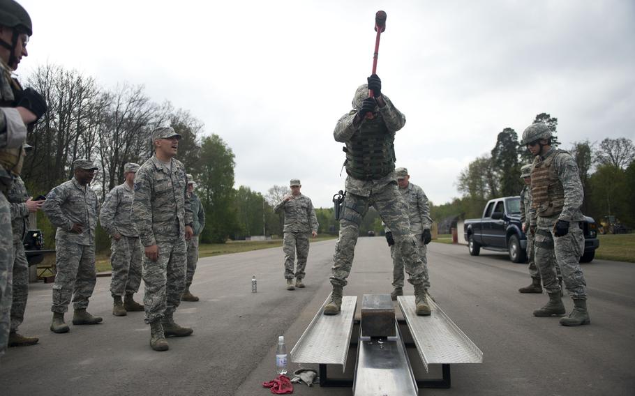 Master Sgt. David Thomas, from the 435th Construction and Training Squadron, hits a block of metal with a sledgehammer during the inaugural 435th Contingency Response Group Olympics at Ramstein Air Base, Germany, on Friday, May 5, 2017.