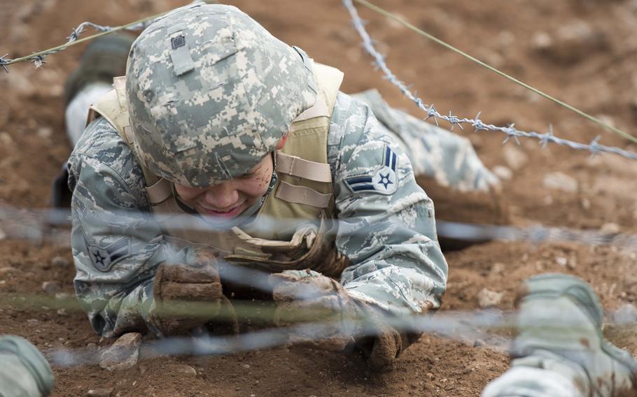 Airman 1st Class Arambulo Miles, from the 435th Construction and Training Squadron, crawls through the dirt during the 435th Contingency Response Group Olympics at Ramstein Air Base, Germany, on Friday, May 5, 2017.