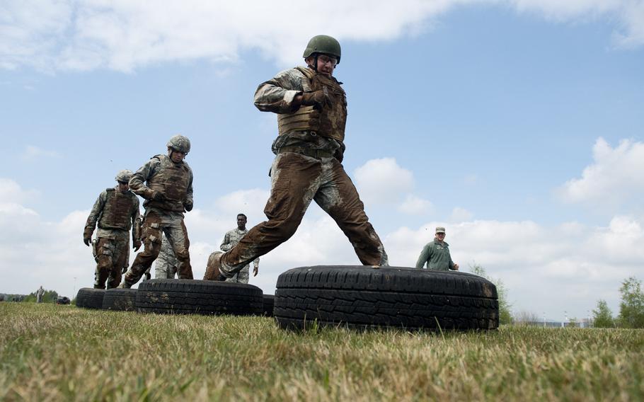Master Sgt. Robert Fitte, from the 435th Construction and Training Squadron, runs through a tire obstacle during the 435th Contingency Response Group Olympics at Ramstein Air Base, Germany, on Friday, May 5, 2017.