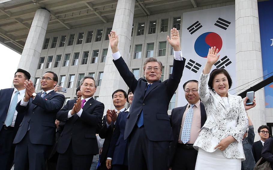 New South Korean President Moon Jae-in and his wife, Kim Jung-suk, wave to supporters in Seoul, Wednesday, May 10, 2017.
