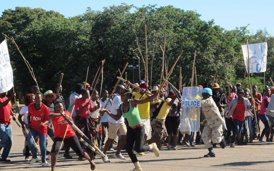 Malawi Defense Force troops and local actors enact a clash between angry protestors and local police during a demonstration of Malawi's peacekeeping battalion's expertise Tuesday, May 9, 2017. The event was part of the African Land Summit 17 hosted by U.S. Army Africa in Lilongwe this week.