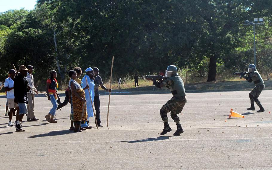 Malawian troops and local actors stage a demonstration of the Malawi peacekeeping battalion's abilities during a demonstration of Malawi's peacekeeping battalion's expertise on Tuesday, May 9, 2017. The event was part of the African Land Summit 17 hosted by U.S. Army Africa in Lilongwe this week.
