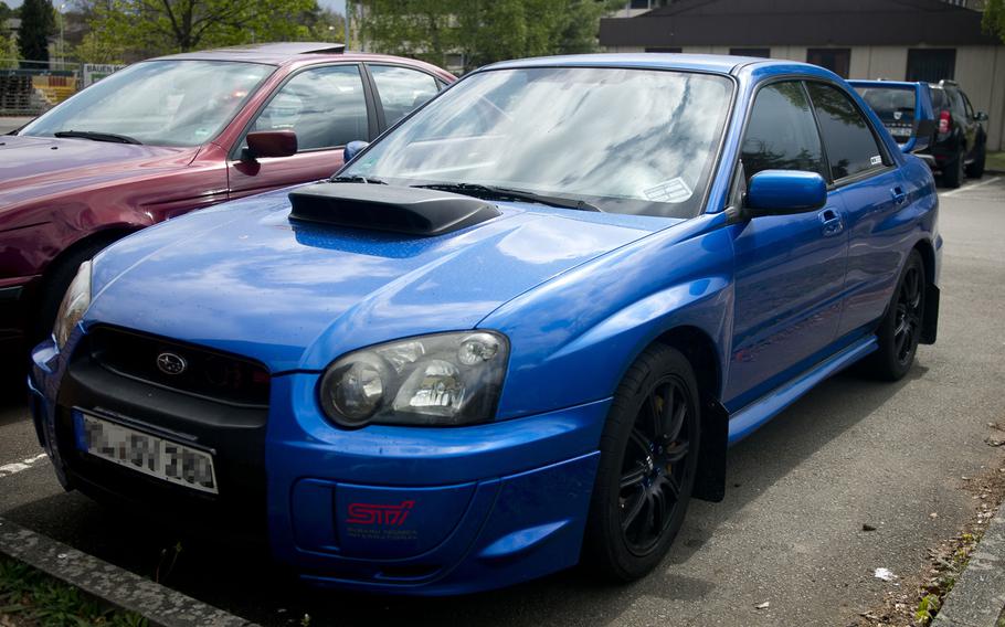 A Subaru Impreza at Ramstein Air Base, Germany, with an extended rear spoiler and hood scoop, April 18, 2017.