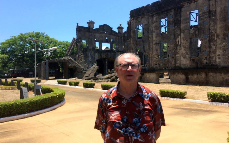 Steve Kwiecinski, 65, of Virginia, Minn., whose Army staff sergeant father was captured by the Japanese on Corregidor during World War II, stands in front of the ruins of an old theater on the Philippine island, Saturday, May 6, 2017.