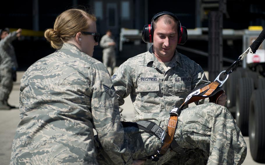 Senior Airmen Christopher Pieczynski, right, and Sarah Isbell assist a simulated fall victim during fall protection training at Ramstein Air Base, Germany, on Wednesday, May 10, 2017.