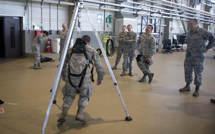 Senior Airman Christopher Pieczynski hangs in a harness during fall protection training at Ramstein Air Base, Germany, on Wednesday, May 10, 2017.