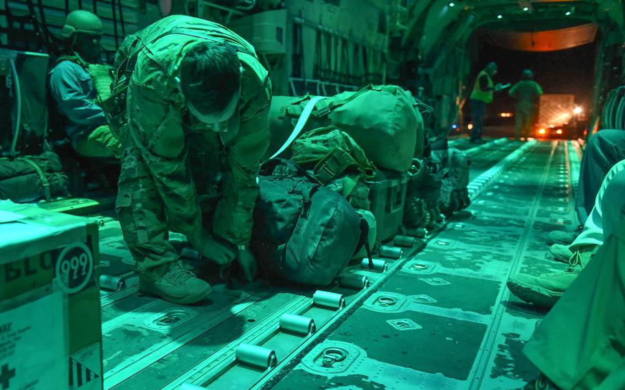 Capt. Brennan Wolford, 29, of Thornville, Ohio, lashes down baggage on a C-130J from the 774th Expeditionary Airlift Squadron at Camp Dwyer, Afghanistan, May 5, 2017.