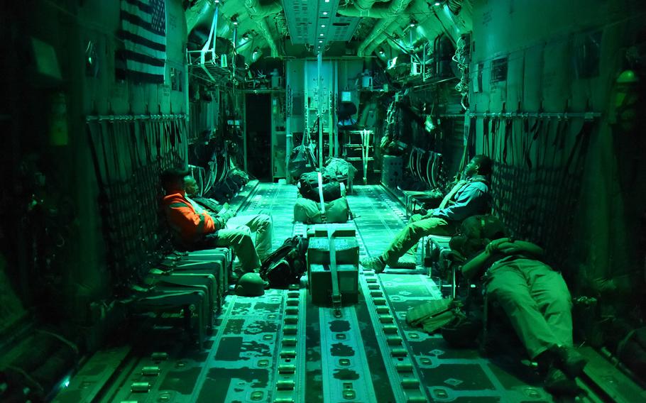 Passengers try to get some sleep on a late night C-130J flight from Kandahar Air Field to Bagram Air Field, Afghanistan, May 5, 2017.