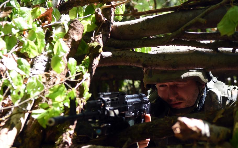 A Polish soldier with American and British forces in Hohenfels, Germany, takes aim and surveys his surroundings during Exercise Saber Junction, Wednesday, May 10, 2017.