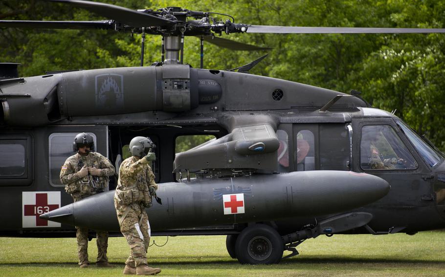 A 12th Combat Aviation Brigade Black Hawk helicopter crew waits for simulated casualties during an exercise at Rhine Ordnance Barracks, Germany, on Thursday, May 11, 2017.