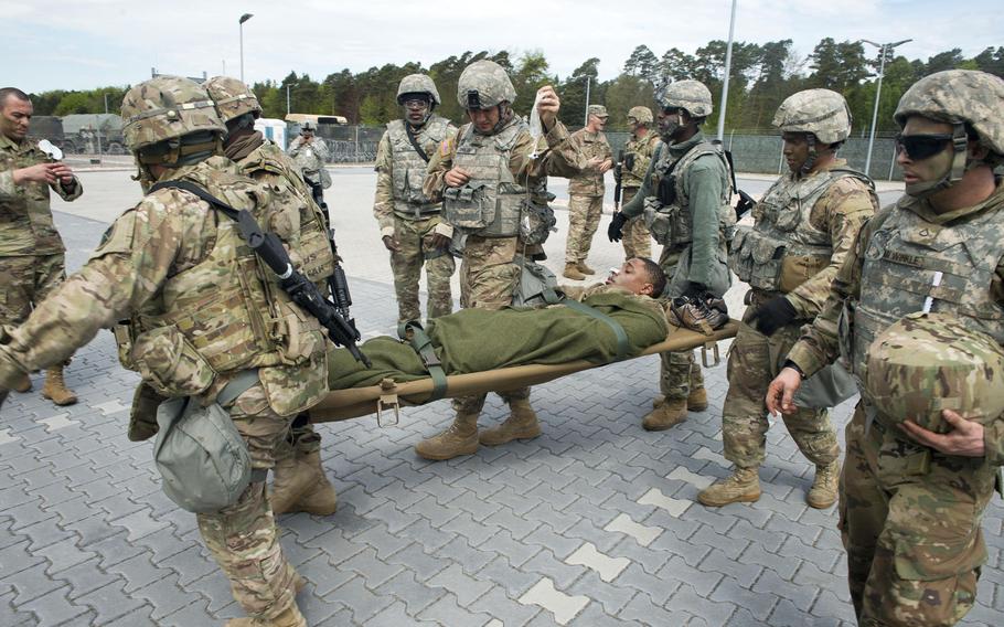 Soldiers from the 5th Battalion, 7th Air Defense Artillery Regiment move a simulated casualty during an exercise at Rhine Ordnance Barracks, Germany, on Thursday, May 11, 2017.