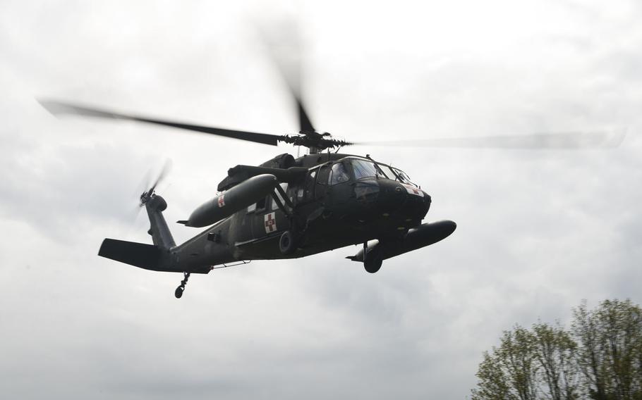 A 12th Combat Aviation Brigade Black Hawk helicopter transports simulated casualties during an exercise at Rhine Ordnance Barracks, Germany, on Thursday, May 11, 2017.