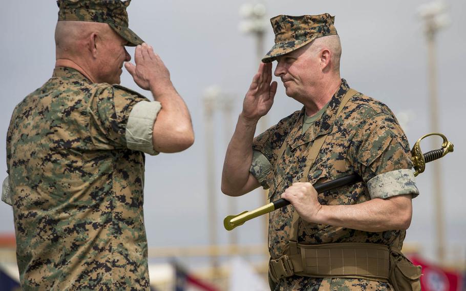 Sgt. Maj. Lee Bonar Jr., right, hands off the sword of the III Marine Expeditionary Force command sergeant major to III MEF's commander, Lt. Gen. Lawrence Nicholson, at Camp Hansen, Okinawa, Friday, May 12, 2017.
