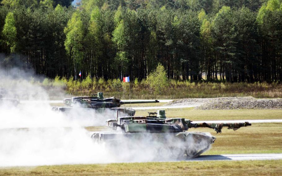 French Leclerc tanks speed to their targets at the Strong Europe Tank Challenge at Grafenwoehr, Germany, Thursday, May 11, 2017.