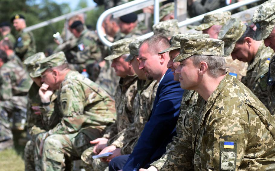 Observers from the United States, Ukraine, Germany and five other nations watch the live-fire portion of the French army tank demonstration during the Strong Europe Tank Challenge at Grafenwoehr, Germany, Thursday, May 11, 2017.