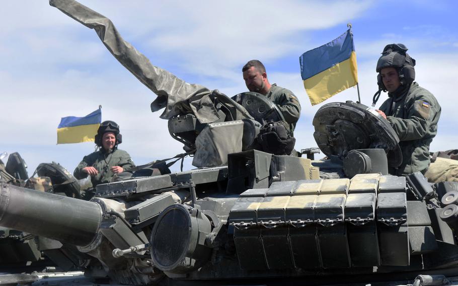 Ukrainian tankers atop a T-64BM tank get ready to maneuver their tank through obstacles during the Strong Europe Tank Challenge at Grafenwoehr, Germany, Thursday, May 11, 2017.