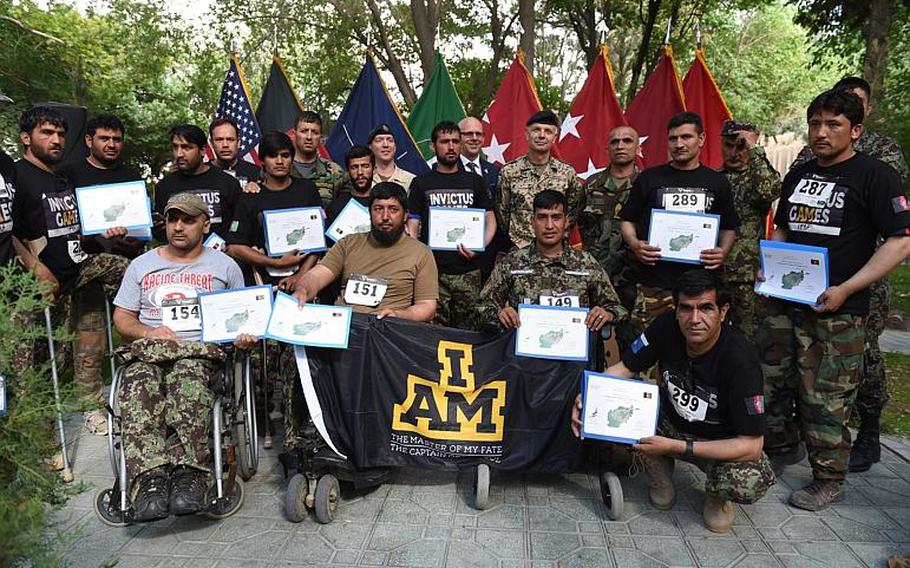 The team of wounded Afghan soldiers selected to represent their country in the 2017 Invictus Games, shows off certificates at the team trials closing ceremony at Resolute Support headquarters, Kabul, Afghanistan, Saturday, May 13, 2017.