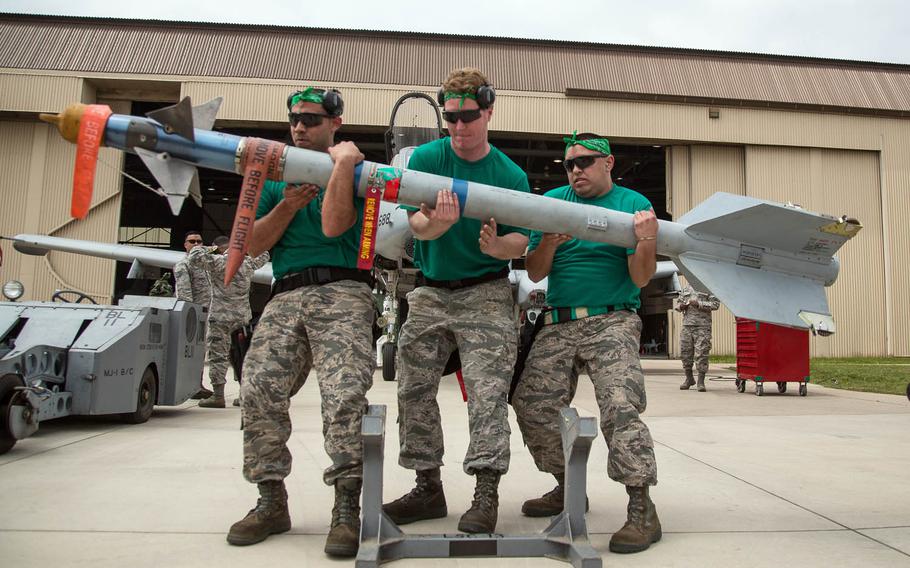 Competitors lift a weapon during the 2017 Annual Load Crew Competition at Kunsan Air Base, South Korea, Saturday, May 13, 2017.