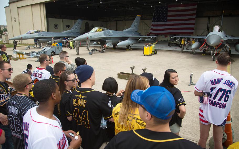 Spectators watch weapons crews from six squadrons compete in the 2017 Annual Load Crew Competition at Kunsan Air Base, South Korea, Saturday, May 13, 2017.