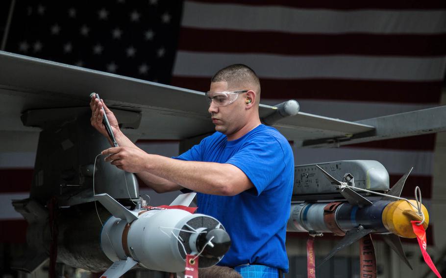 A competitor loads a bomb onto a jet during the 2017 Annual Load Crew Competition at Kunsan Air Base, South Korea, Saturday, May 13, 2017.