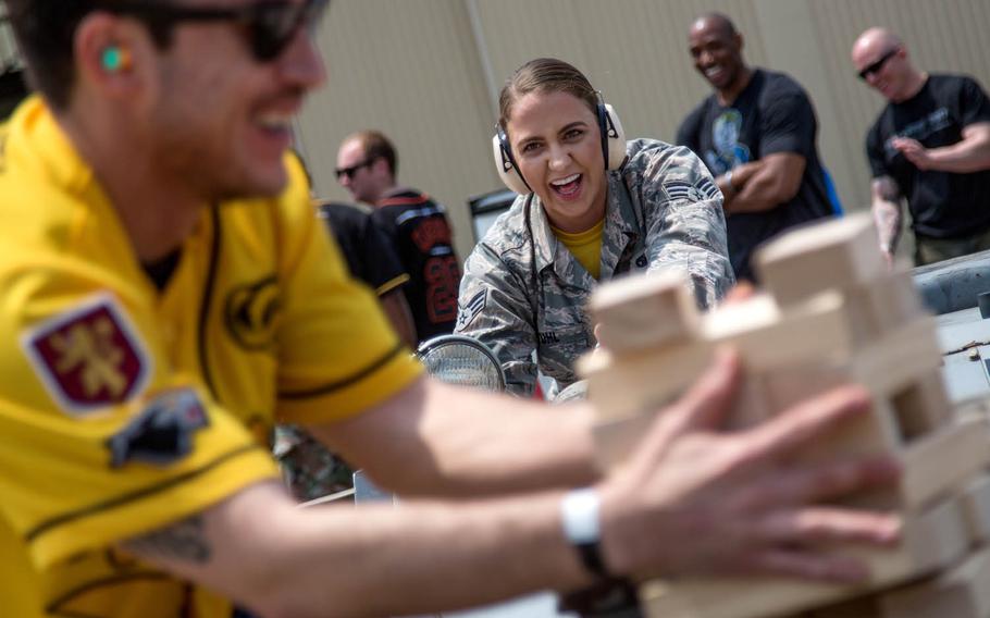 A competitor knocks down her tower during "jammer jenga" at the 2017 Annual Load Crew Competition, Kunsan Air Base, South Korea, Saturday, May 13, 2017.