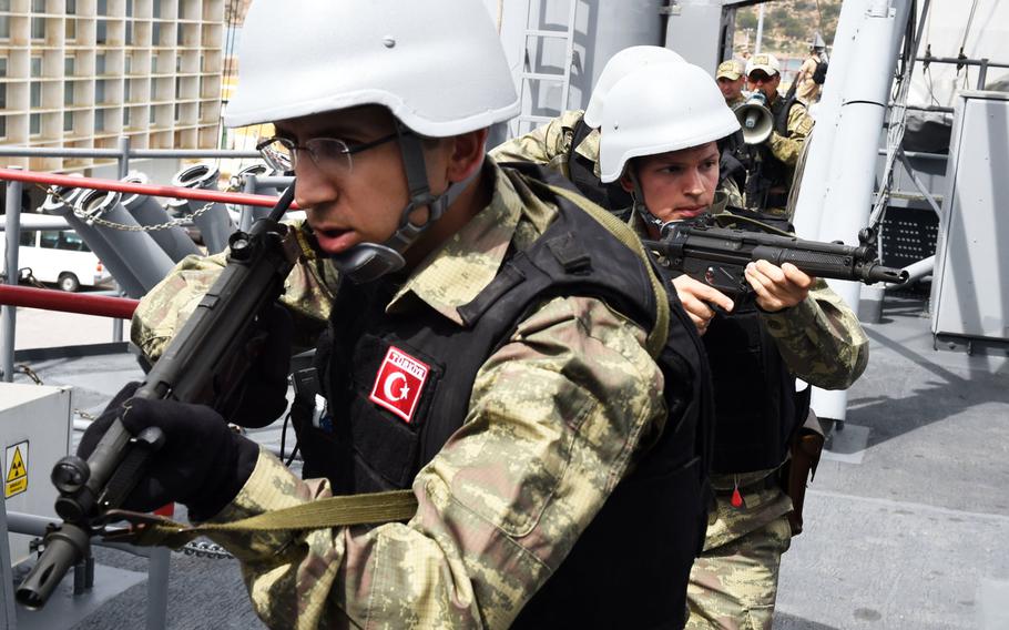 Turkish boarding teams practice a simulated raid on the Turkish frigate TCG Gokceada on Thursday, May 11, 2017, during Phoenix Express in Cartagena, Spain. The multinational exercise seeks to improve countries' maritime policing skills and cooperation between countries to strengthen security in the Mediterranean.