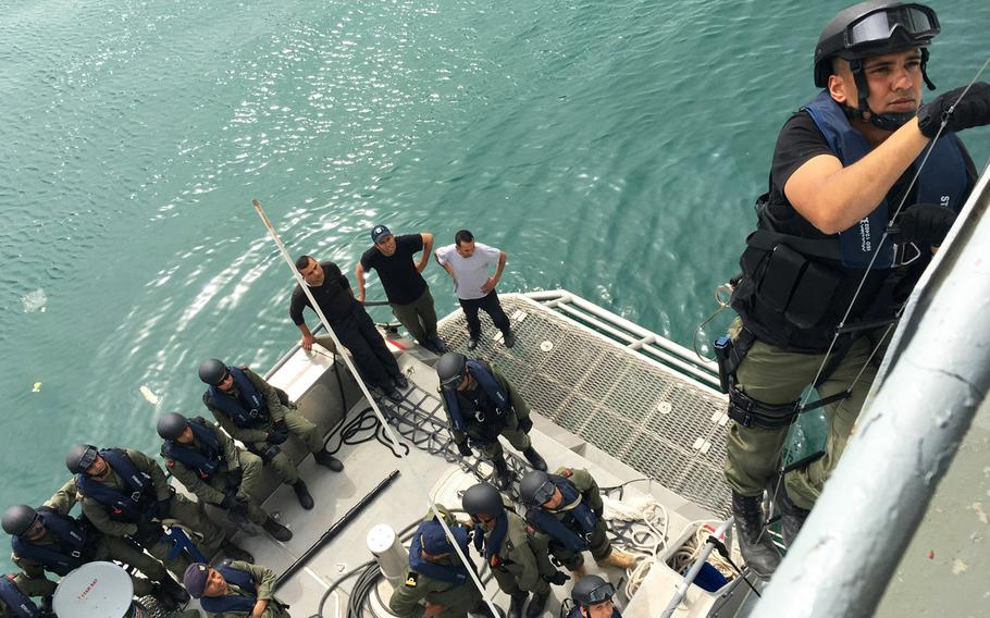 In a simulated raid, Tunisian sailors practice search and seizure techniques during the at-sea phase of Phoenix Express on Thursday, May 13, 2017, in Bizerte, Tunisia.