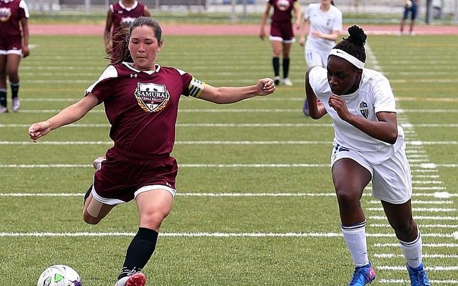 Matthew C. Perry's Bobbi Hill launches a shot against Yokota's Jamia Bailey during Tuesday's pool-play match in the Far East Girls Division II Soccer Tournament, won by the Samurai 4-0. AUSTIN LIVENGOOD/SPECIAL TO STRIPES