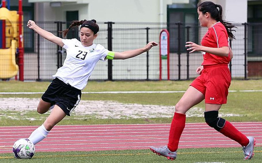 Daegu's Ashley Clifton boots the ball against E.J. King's Ayumi Murphy during Tuesday's pool-play match in the Far East Girls Division II Soccer Tournament, won by the Cobras 1-0. AUSTIN LIVENGOOD/SPECIAL TO STRIPES