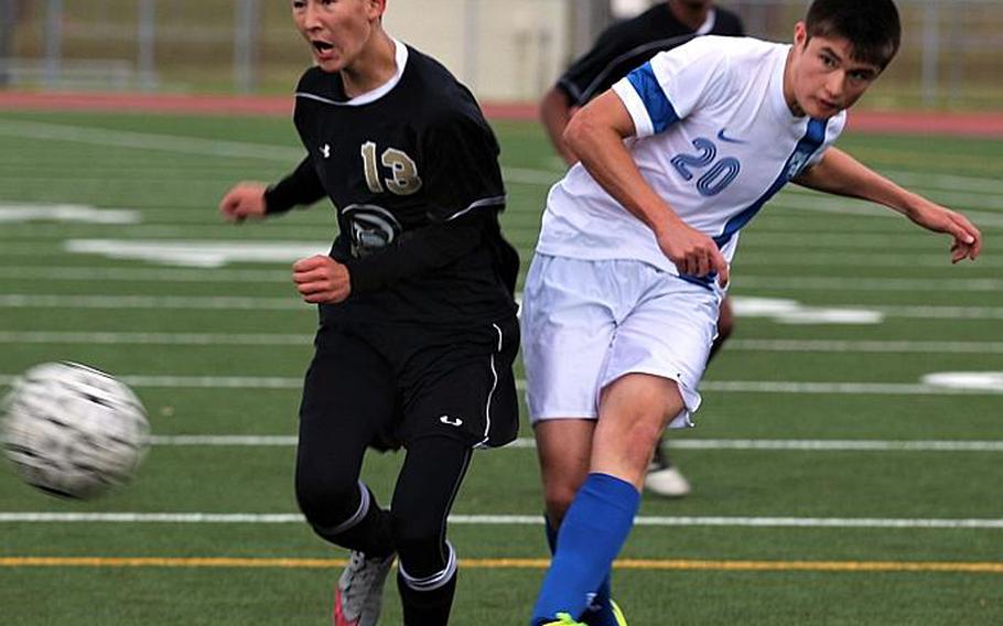 Humphreys' Christian Saavedra and Christian Academy Japan's Kevin Nelson try to play the ball during Tuesday's pool-play match in the Far East Boys Division II Soccer Tournament, won by the Knights 16-0. CAITLIN BLOUNT/SPECIAL TO STRIPES