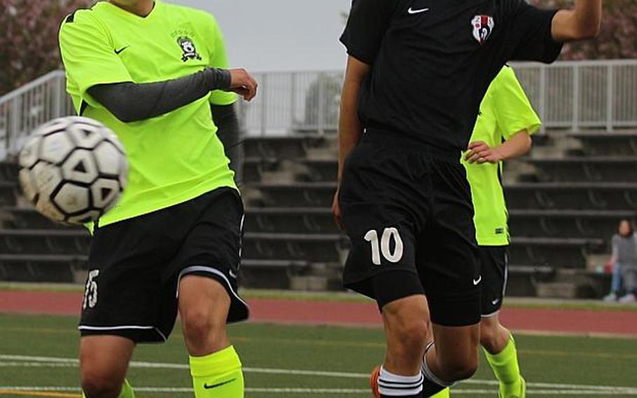 Matthew C. Perry's Lorenzo Hernandez and Zama's Matthew Araki try to play the ball during Tuesday's pool-play match in the Far East Boys Division II Soccer Tournament, won by the five-time defending champion Samurai 4-0. CAITLIN BLOUNT/SPECIAL TO STRIPES
