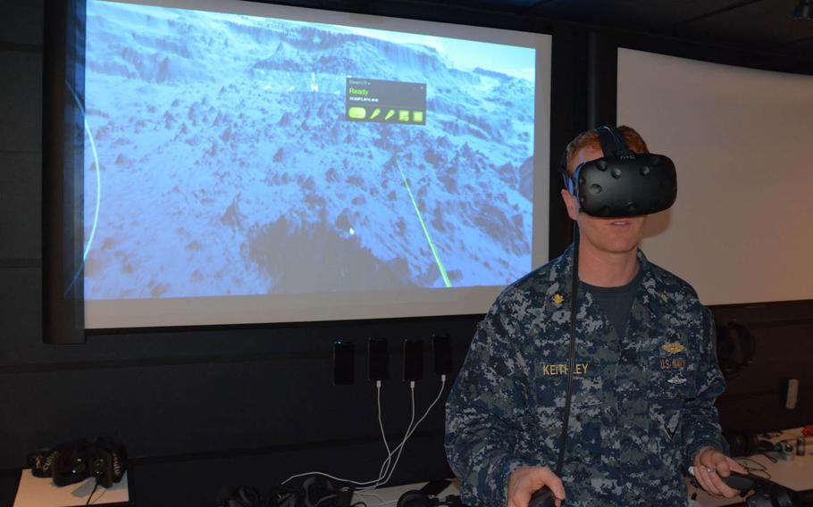 Lt. Cmdr. Christopher Keithley demonstrates a prototype that combines 3-D mapping of the ocean floor with virtual-reality goggles and handsets that could be used for submariner training. It is one of the ideas now in the pipeline at iLab, an innovation center at Joint Base Pearl Harbor-Hickam, Hawaii.