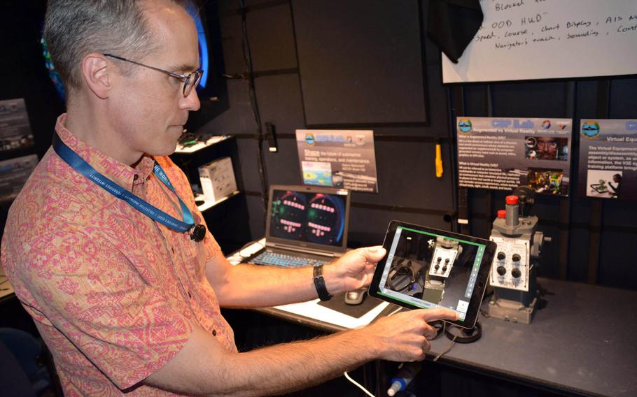 Chris Bretz, iLab manager, uses a computer tablet to demonstrate a prototype of a virtual repair manual.