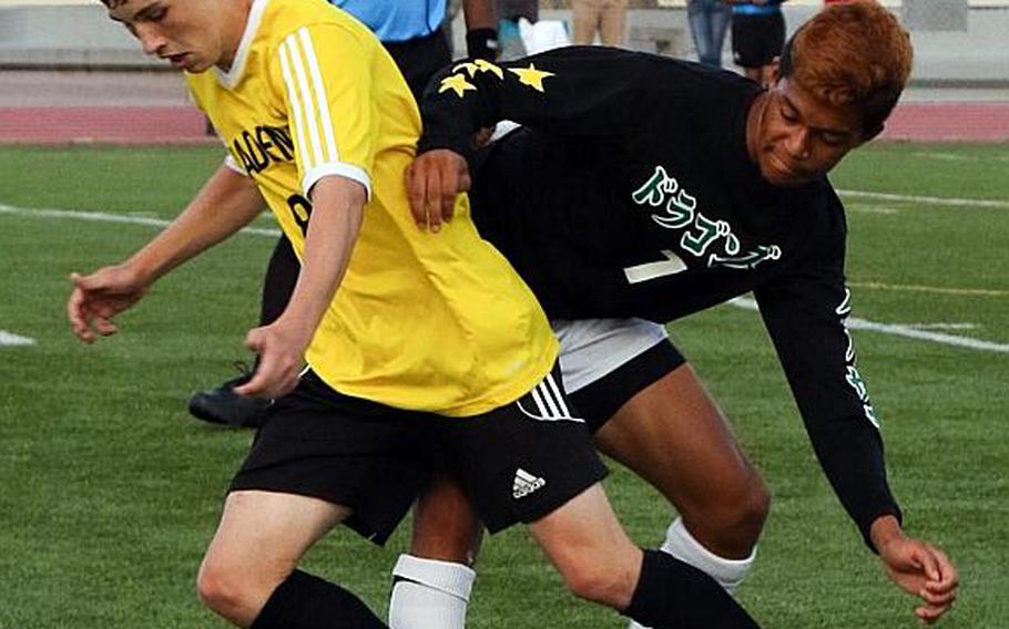 Kadena's Carter Rhodehouse and Kubasaki's Ryo Elliot battle for the ball during Wednesday's Far East Boys Division I Soccer Tournament final. The Panthers dethroned the Dragons 1-0 in overtime for their third D-I title in five years. MARY OBSUNA/SPECIAL TO STRIPES