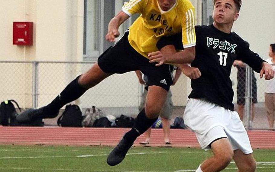 Kadena's Guy Renquist heads the ball against Kubasaki's Luke Moseley during Wednesday's Far East Boys Division I Soccer Tournament final. The Panthers dethroned the Dragons 1-0 in overtime for their third D-I title in five years. MARY OBSUNA/SPECIAL TO STRIPES