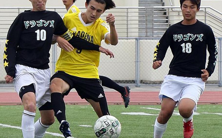 Kadena's Kian Smith gets sandwiched between Kubasaki's Matthew Lemasters and Kaisei Taylor during Wednesday's Far East Boys Division I Soccer Tournament final. The Panthers dethroned the Dragons 1-0 in overtime for their third D-I title in five years. MARY OBSUNA/SPECIAL TO STRIPES