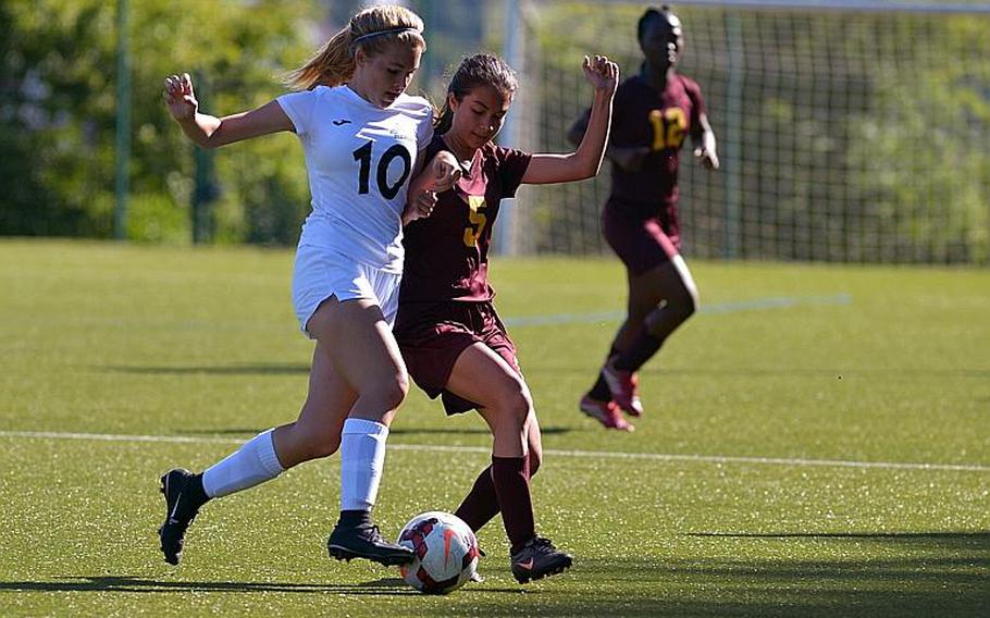 Naples' Kylie Harrison, left, and Vilseck's Angelica Scroggs battle for a ball in Division I action at the DODEA-Europe soccer championships in Reichenbach, Germany. Naples won 7-0.
