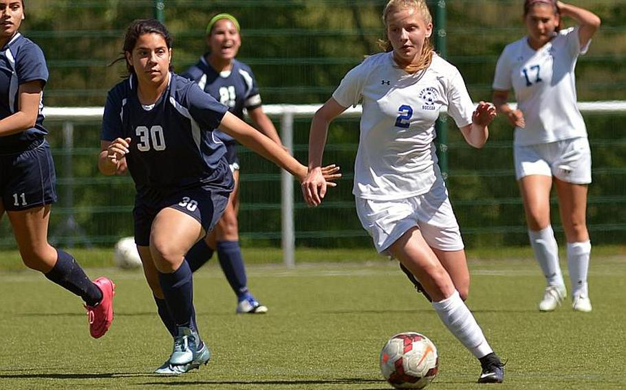 Wiesbaden's Peggy Sue Mathis gets away from Lakenheath's Madison Long in Division I action at the DODEA-Europe soccer championships in Reichenbach, Germany. Wiesbaden won 4-0.