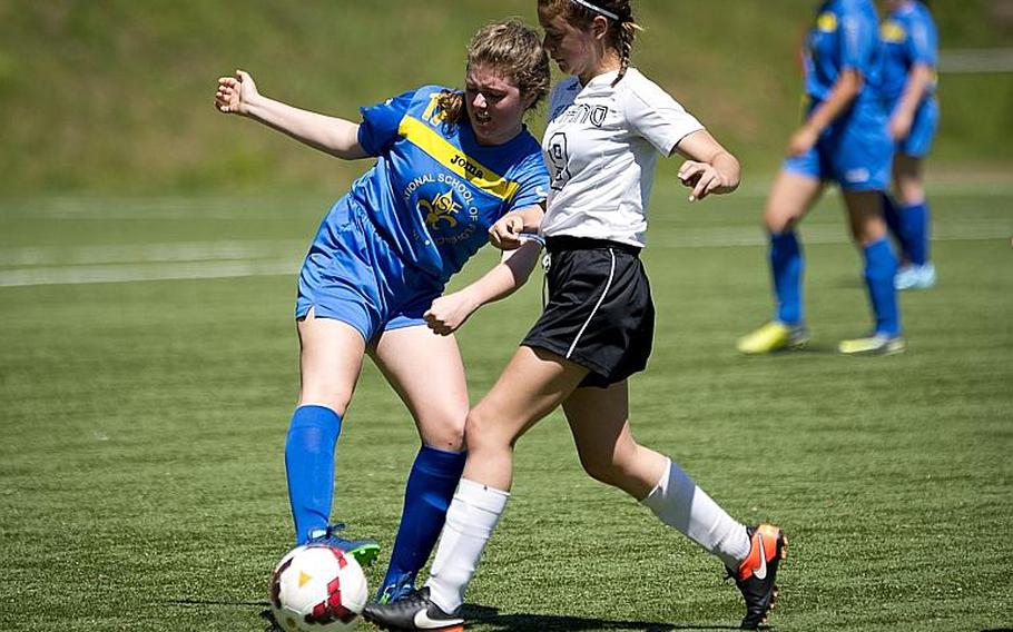Florence's Sarah Amantini, left, clears the ball past Aviano's Alyssa Mendez during the DODEA-Europe soccer tournament in Landstuhl, Germany, on Wednesday, May 17, 2017. Florence lost the Division II match 4-0. MICHAEL B. KELLER/STARS AND STRIPES