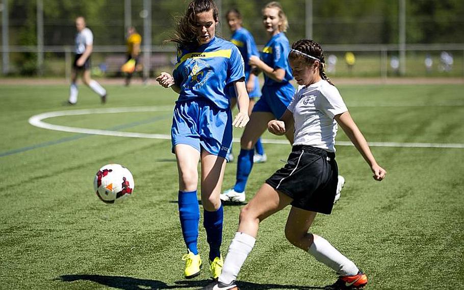 Aviano's Alyssa Mendez, right, passes the ball past Florence's Sophie De Godoy Van Wij during the DODEA-Europe soccer tournament in Landstuhl, Germany, on Wednesday, May 17, 2017. Aviano won the Division II match 4-0. MICHAEL B. KELLER/STARS AND STRIPES
