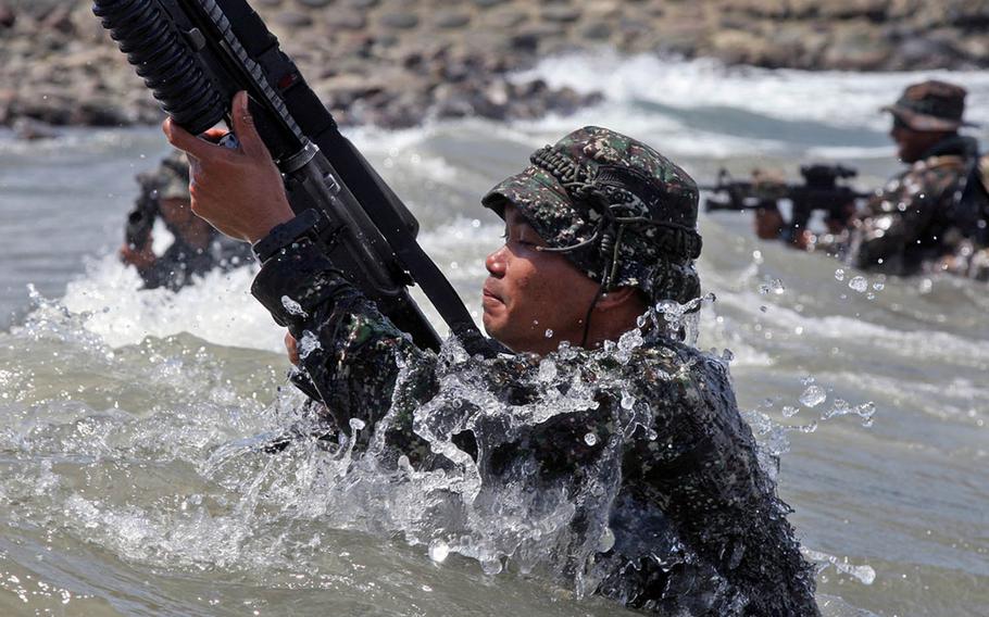 Philippine and U.S. Marines assigned to the Fleet Anti-terrorism Security Team Pacific fight against the waves during an amphibious beach assault exercise in General Santos City, Philippines, in 2012.