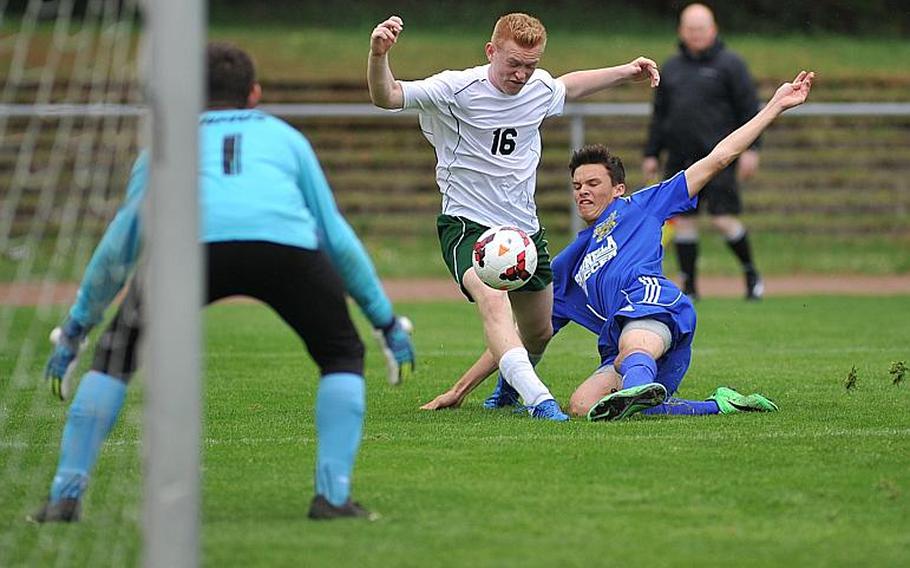 Sigonella's Isaac Griswold, right, clears the ball in front of Alconbury's Monroe Potter as Sigonella keeper Cameron Camus watches. Sigonella beat Alconbury 4-3 in Division III action at the DODEA-Europe soccer championships in Landstuhl, Germany.