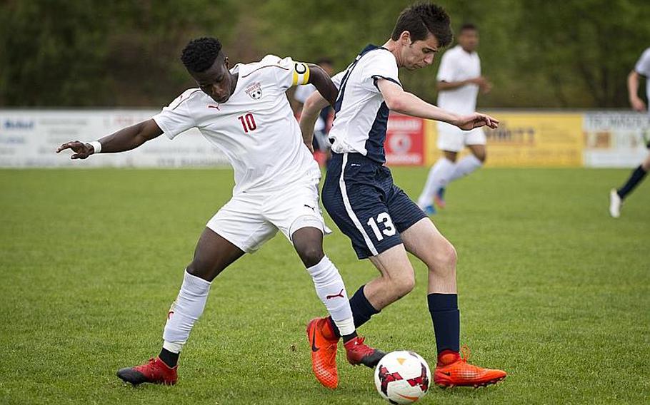 Kaiserslautern's Alexander Dexter, left, challenges Lakenheath's Riley Fleming during the DODEA-Europe soccer tournament in Reichenbach, Germany, on Thursday, May 18, 2017. Kaiserslautern won the Division I match 5-0 and advanced to the semifinals. MICHAEL B. KELLER/STARS AND STRIPES