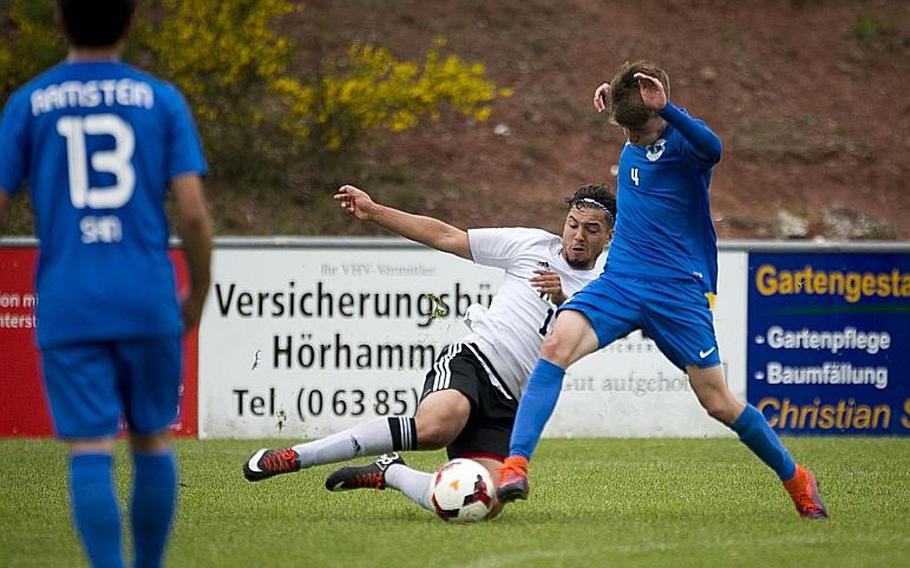Vicenza's Christopher Ortiz, left, slides to challenge Ramstein's Gavin McMillan during the DODEA-Europe soccer tournament in Reichenbach, Germany, on Thursday, May 18, 2017. Ramstein and Vicenza tied the Division I match 1-1 and Ramstein advances to the semifinals. MICHAEL B. KELLER/STARS AND STRIPES