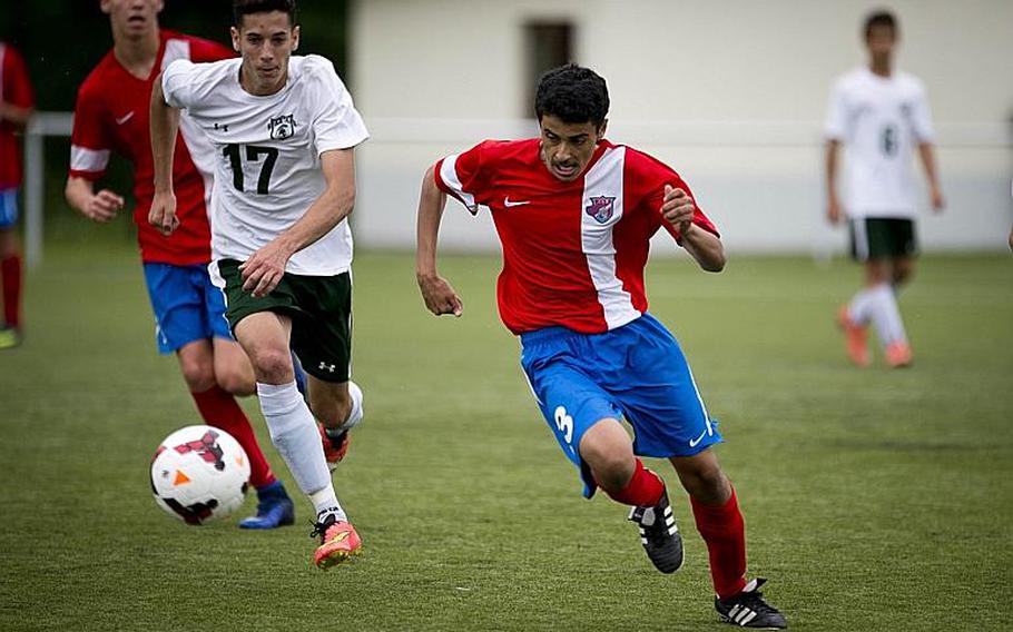 International School of Brussels' Khalifa Hanash, right, runs down the field as SHAPE's Alvaro Segura tries to catch up during the DODEA-Europe soccer tournament in Reichenbach, Germany, on Thursday, May 18, 2017. SHAPE and ISB tied the Division I match 1-1. MICHAEL B. KELLER/STARS AND STRIPES