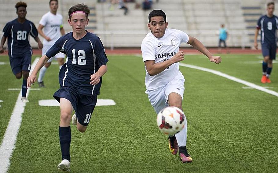 Bitburg's Mike Ohl, left, and Bahrain's Carlos Barrero race for the ball during the DODEA-Europe soccer tournament in Kaiserslautern, Germany, on Thursday, May 18, 2017. Bitburg won the Division II match 1-0. MICHAEL B. KELLER/STARS AND STRIPES