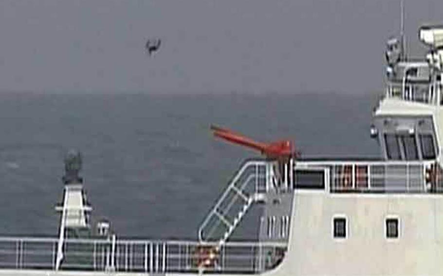What appears to be a drone aircraft flies near Chinese coast guard vessels that entered Japanese waters near the Senkaku Islands, Thursday, May 18, 2017.