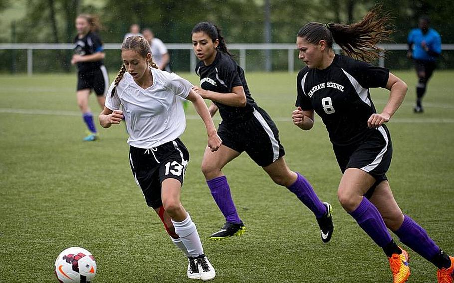 AFNORTH's Kyla Kolosky dribbles the ball ahead of Bahrain's Christina Lopez, right, and Asmaa Hussein during the DODEA-Europe Division II semifinals in Reichenbach, Germany, on Friday, May 19, 2017. AFNORTH won the match 2-1 in double overtime. MICHAEL B. KELLER/STARS AND STRIPES